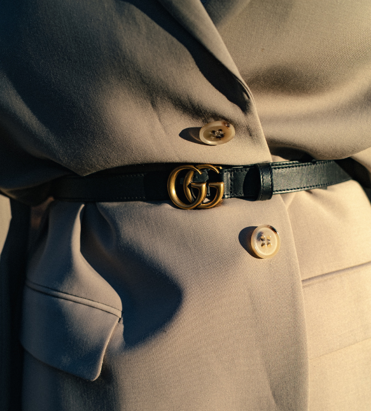 close up of blazer jacket and designer belt