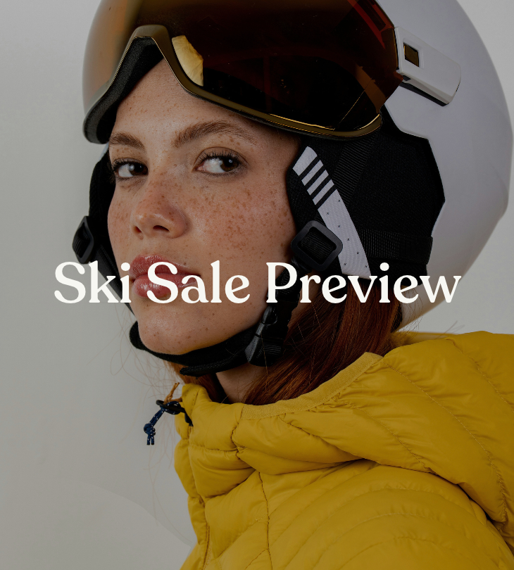 Ski Sale Preview: skier wearing a white helmet, goggles, and a yellow jacket.
