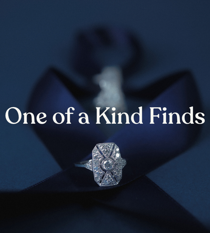 One of a Kind Finds: ornate rectangular gemstone ring displayed against dark blue ribbon.