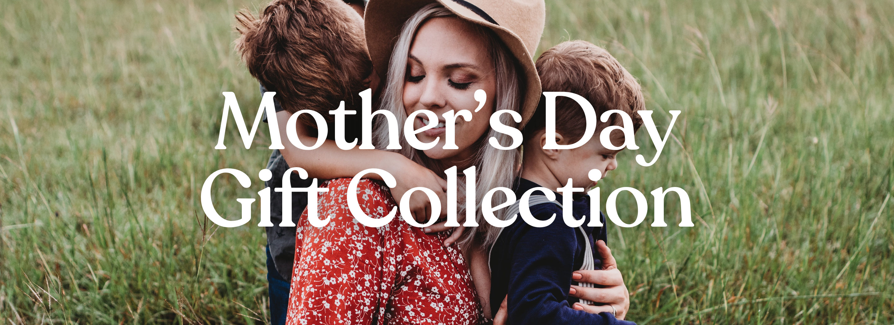Mother's Day Gift Collection caption. A mother hold two children on a field