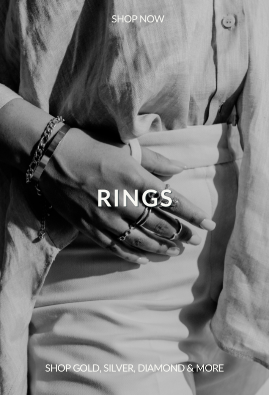 black and white photo of someone with rings on their hand