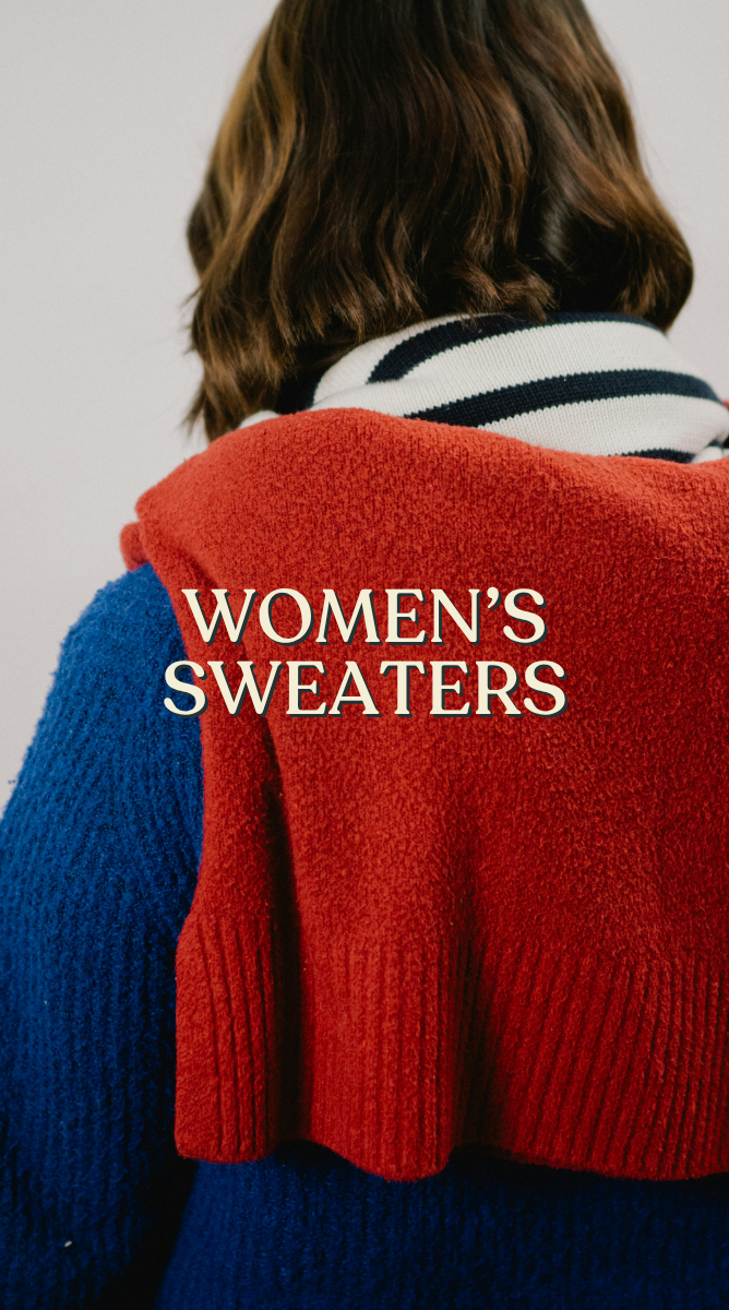 Women’s sweaters: Model wearing a blue sweater with a red sweater draped over their shoulders.