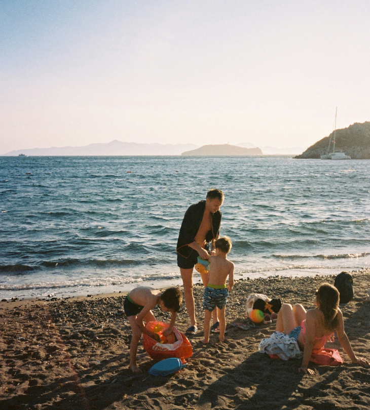 a group of family relaxing by the beach on a sunny day