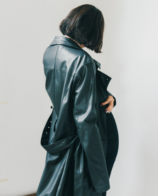 a woman in a black leather coat