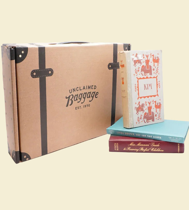a unclaimed baggage kraft box with books