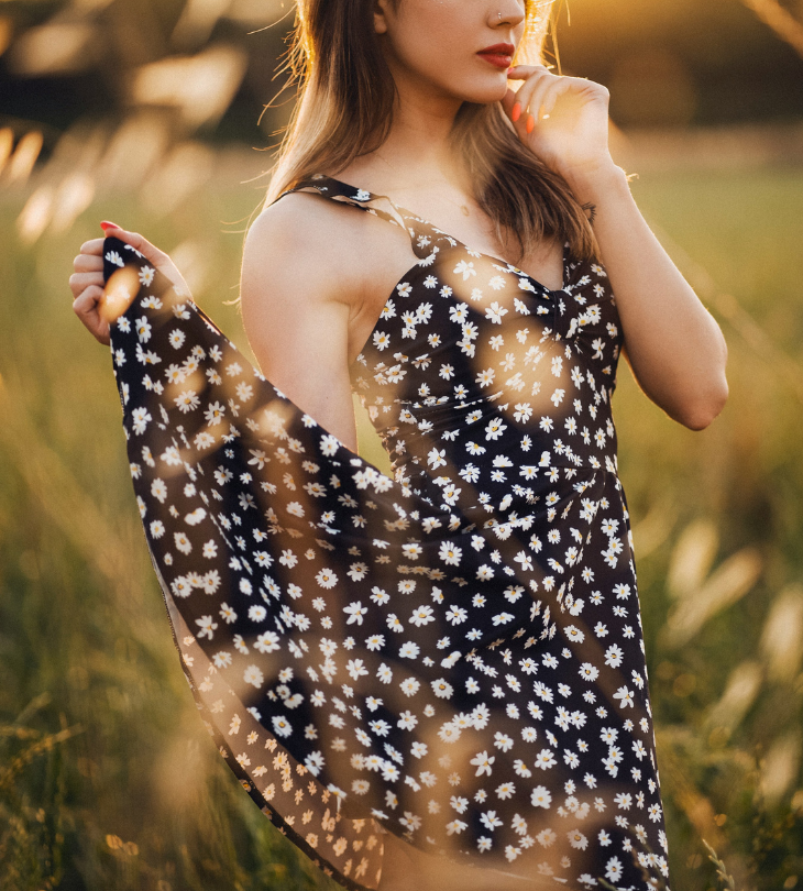woman in field with flower printed dress