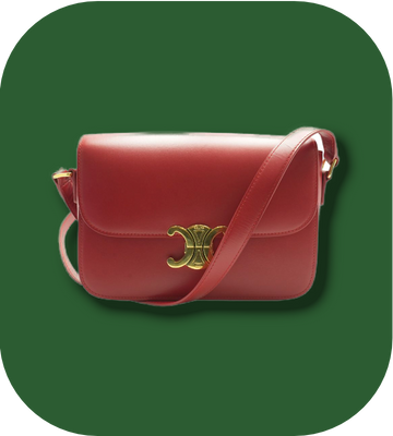 Red handbag with gold clasp on a green background