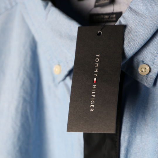 a blue button down shirt with a Tommy Hilfiger hang tag